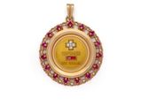 a close up of a gold pendant with a cross on it
