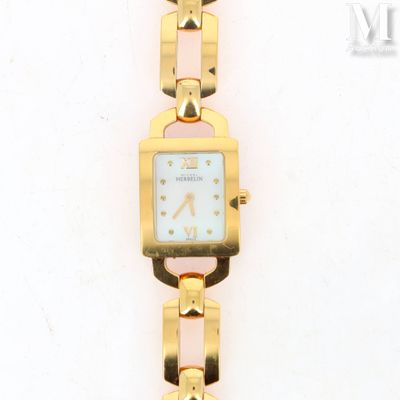 an image of a gold wrist watch with a white face