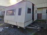 a white trailer parked in front of a building