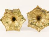 pair of antique brass candlestick holders on a white background