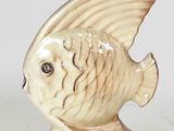 a ceramic fish figurine sitting on a white surface