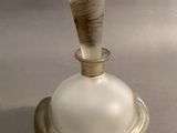 a glass bottle with a wooden stick sticking out of it