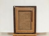 an old picture frame sitting on top of a wooden easel
