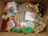 a cardboard box filled with assorted items for a child ' s play
