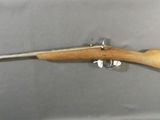 a rifle with a wooden barrel and a wooden handle