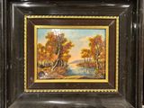 an oil painting of a river scene in a black frame