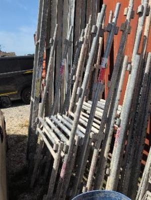a lot of wooden sticks and a bucket of water