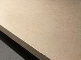 a wooden table with a metal base on a carpeted floor