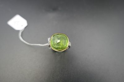 a close up of a green ring on a black surface