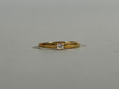 a close up of a gold ring with a diamond on it
