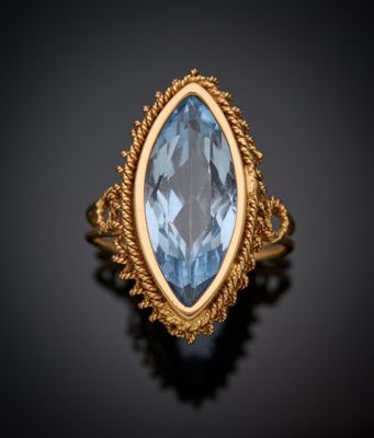 une bague en or sertie d'une topaze bleue au centre