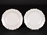 two white plates are sitting on a black surface