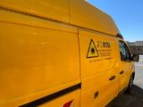 a yellow van that is parked in a parking lot