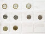 a lot of coins that are in a white box