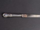 a knife that is laying on a black surface
