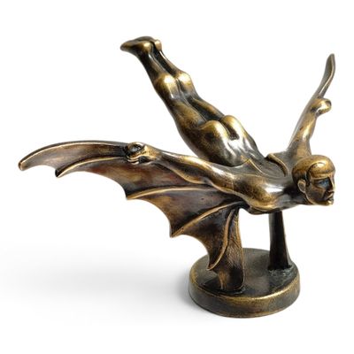 bronze figurine of a flying bat on a pedestal