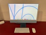 a computer monitor and keyboard on a red desk
