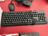 a computer keyboard and mouse sitting on a red table