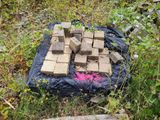 a pile of bricks sitting on a tarp in the grass