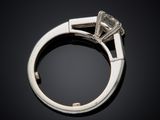 a close up view of a diamond ring on a black surface