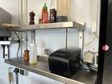 a toaster and a toaster on a shelf in a kitchen