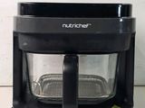 a black blender sitting on a counter with a white background