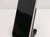 a cell phone that is on a stand on a table