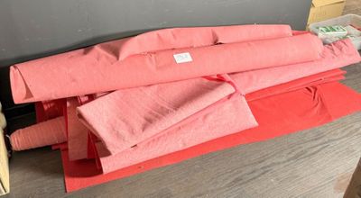 a pile of pink towels sitting on top of a red box