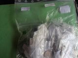 a plastic bag with a coin in it sitting on a table