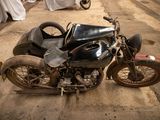 an old motorcycle that is parked on the side of the road