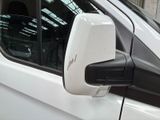 a side view mirror of a white car with a black trim