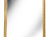 a gold framed mirror on a white background