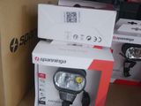 two boxes on a shelf with a light on top of it