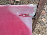 a red stain on the fabric of a chair