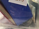 a stack of books in a plastic container with a price tag on it