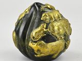 an image of a gold and black sculpture of a lion on a rock