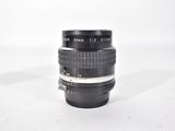 a black camera lens sitting on a white surface