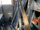 a pile of metal pipes in a room next to a window