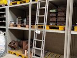 a ladder that is leaning against a wall in a warehouse