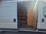 a white van with a wooden door and stairs in the back