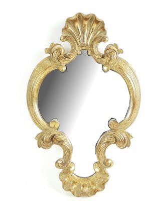 l'image d'un miroir doré sur un mur blanc