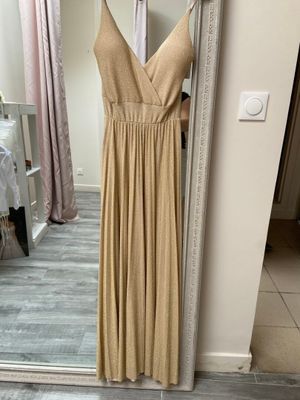 dress on a hanger in front of a mirror in a room