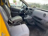the interior of a car with the door open and the driver ' s seat down