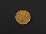 a close up of a gold coin on a black surface
