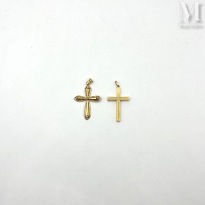 a pair of gold crosses on a white background