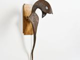 an image of a sculpture of a bird hanging on a wall