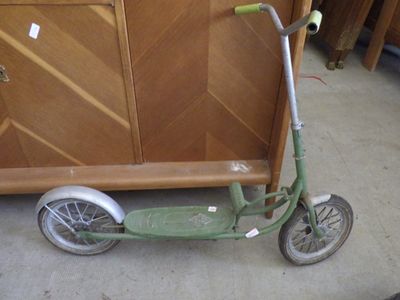 a scooter that is sitting on the floor in front of a cabinet