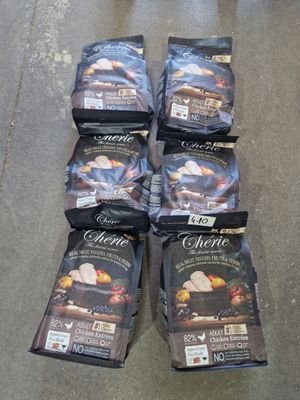 several bags of food sitting on the floor next to each other