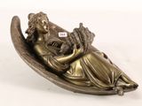 bronze figurine of a woman sitting on a boat holding a baby