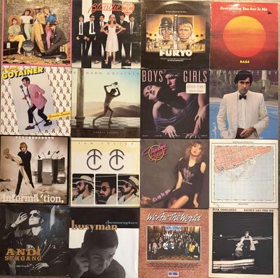 a lot of album covers on the wall of a room